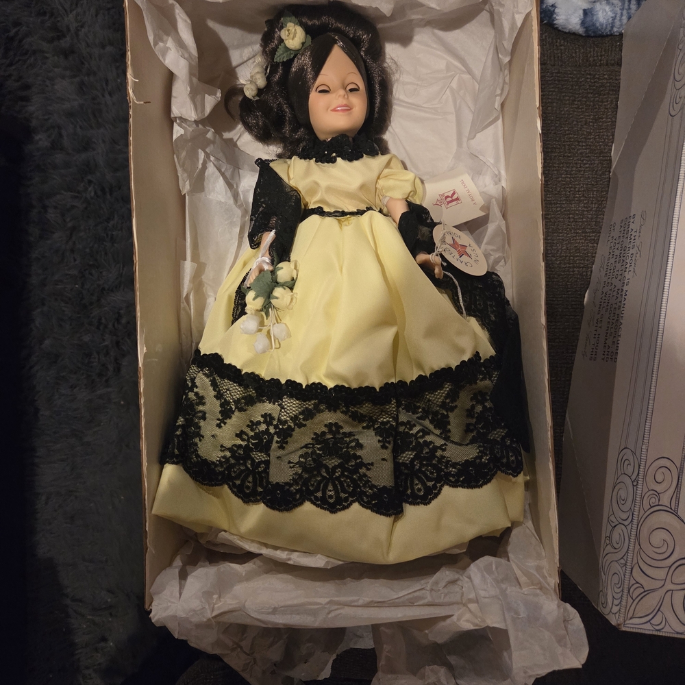 Elegant Yellow and Black Doll with Floral Details